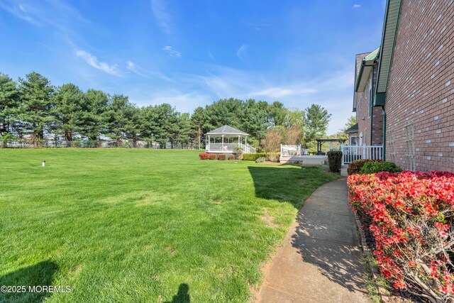 view of yard featuring a gazebo and a wooden deck