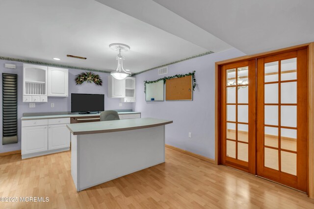 kitchen featuring visible vents, open shelves, white cabinetry, and light wood finished floors