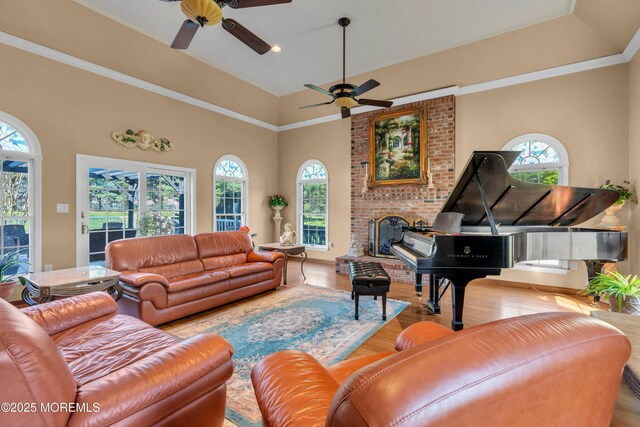 living room featuring ceiling fan, plenty of natural light, and wood finished floors