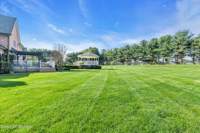 view of yard featuring a wooden deck and a gazebo