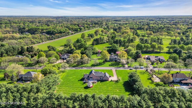 birds eye view of property featuring a wooded view