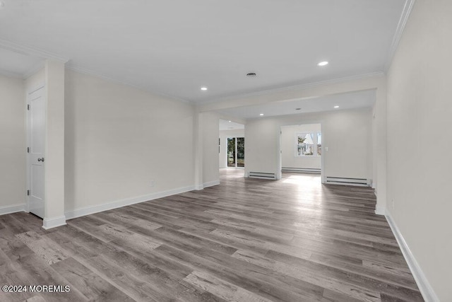 unfurnished living room with wood finished floors, crown molding, baseboards, a baseboard radiator, and recessed lighting