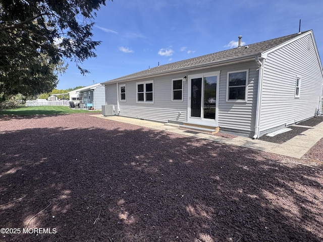 back of house with central AC unit, entry steps, and fence