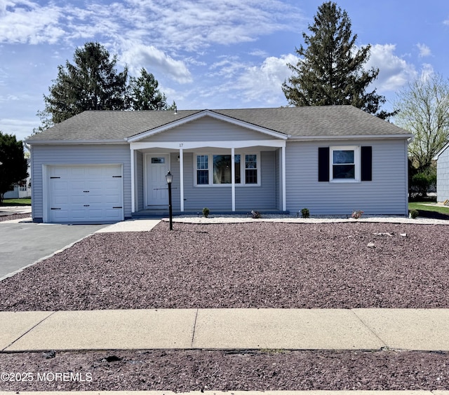 ranch-style house with a porch, driveway, and a garage