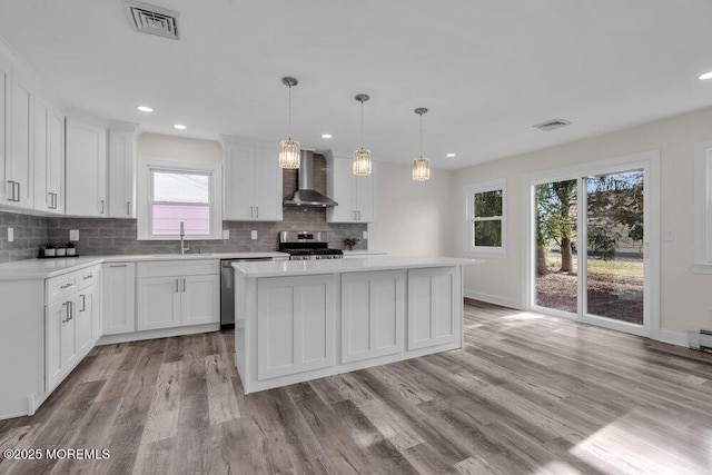 17 Norfolk Dr, Toms River, NJ 08757 - kitchen with wall chimney range hood, appliances with stainless steel finishes, a sink, light countertops, and recessed lighting