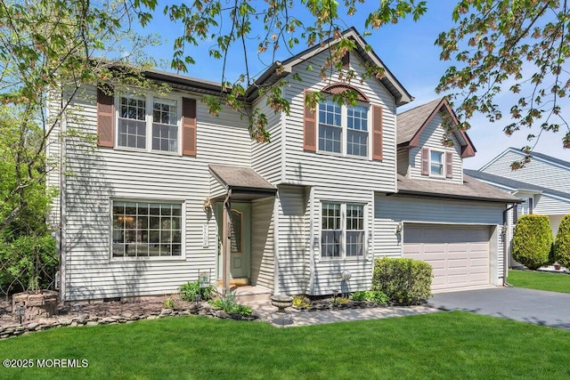 traditional home with concrete driveway, a front yard, and a garage