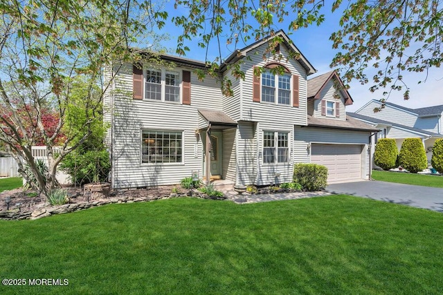 traditional-style house featuring a garage, driveway, and a front lawn
