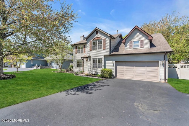 traditional home featuring fence, a front lawn, aphalt driveway, a garage, and a chimney