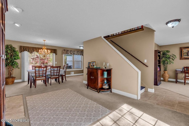 dining space featuring carpet floors, an inviting chandelier, stairs, baseboards, and a textured ceiling