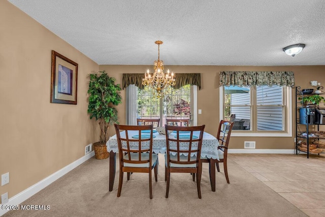 dining area with a textured ceiling, visible vents, baseboards, an inviting chandelier, and light carpet