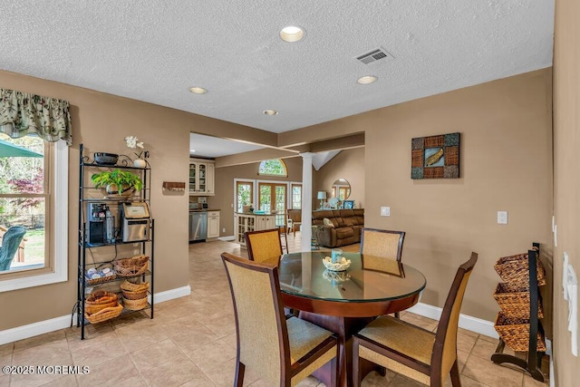dining space featuring visible vents, recessed lighting, a textured ceiling, and baseboards