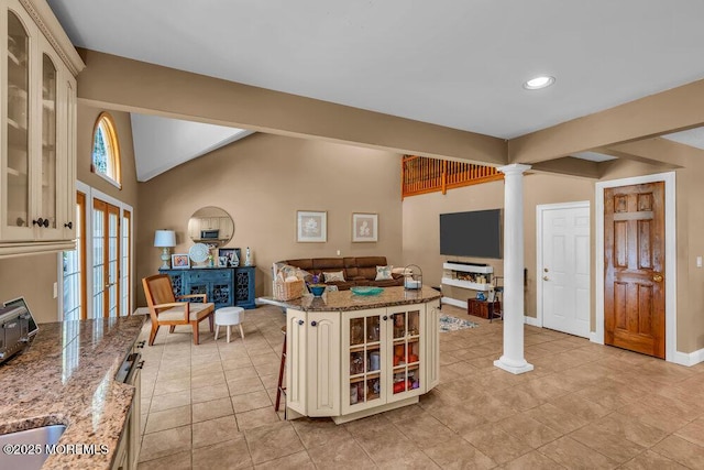 interior space featuring recessed lighting, baseboards, light tile patterned floors, ornate columns, and vaulted ceiling