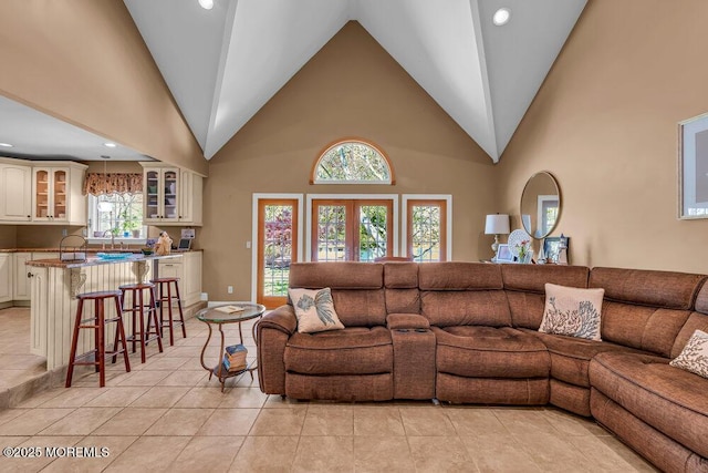 living room featuring high vaulted ceiling, recessed lighting, and light tile patterned flooring