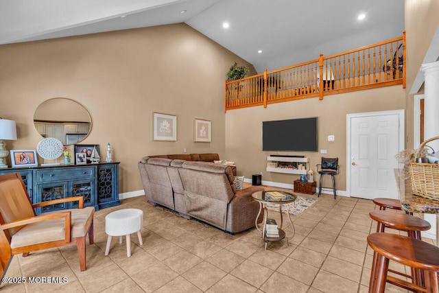 living room featuring light tile patterned flooring, high vaulted ceiling, recessed lighting, and baseboards