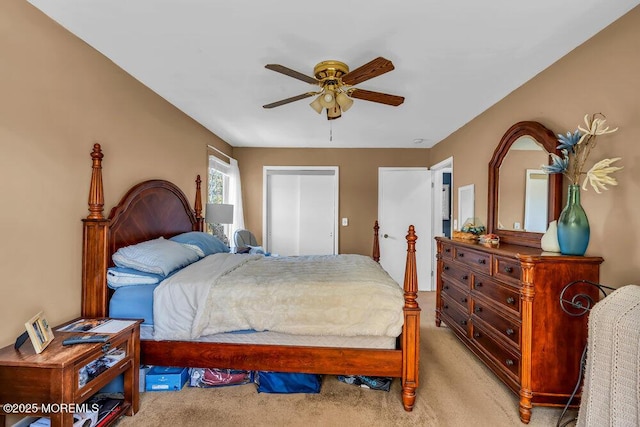 bedroom with light carpet and a ceiling fan
