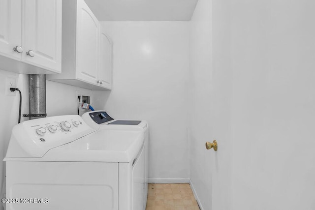 washroom with separate washer and dryer, baseboards, and cabinet space