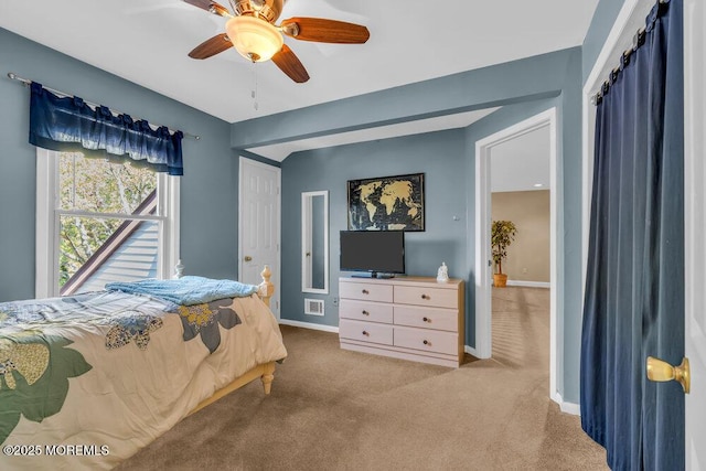 carpeted bedroom featuring baseboards, ceiling fan, and visible vents