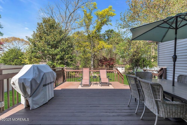 deck featuring outdoor dining area and area for grilling