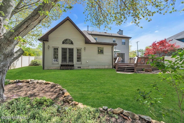 back of property with fence, a wooden deck, entry steps, a chimney, and a yard