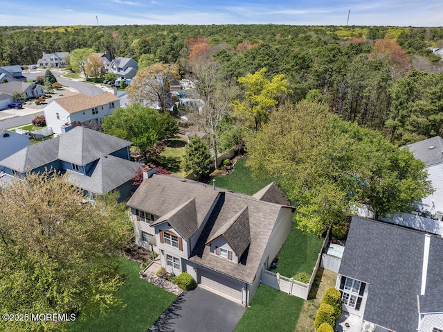 bird's eye view featuring a view of trees and a residential view