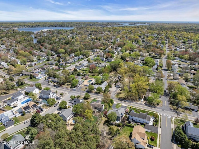 drone / aerial view with a water view and a residential view