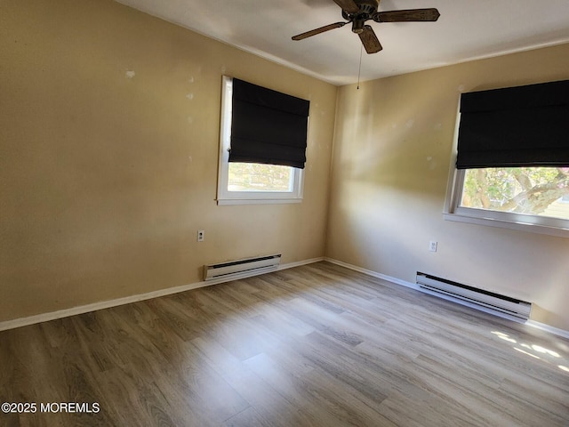 unfurnished room featuring a ceiling fan, baseboards, wood finished floors, and a baseboard radiator