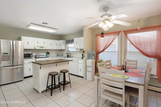 471 Saint Thomas Dr, Toms River, NJ 08757 - kitchen with visible vents, appliances with stainless steel finishes, a sink, light tile patterned floors, and under cabinet range hood