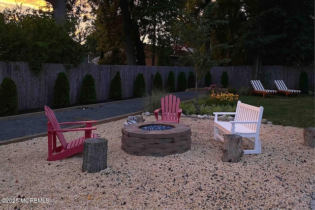 view of patio / terrace with an outdoor fire pit and fence
