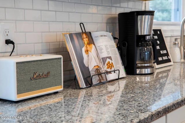 kitchen view of heating unit, tasteful backsplash, and stone countertops