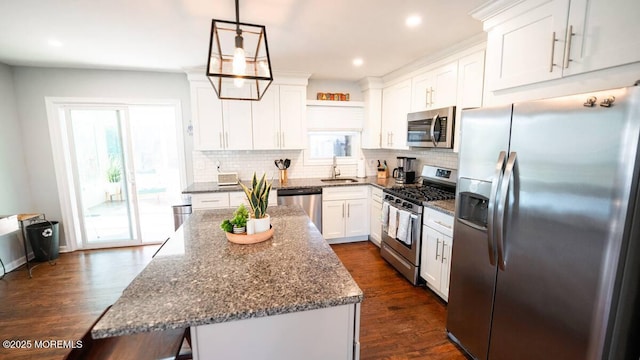kitchen featuring appliances with stainless steel finishes, a sink, decorative backsplash, white cabinets, and recessed lighting