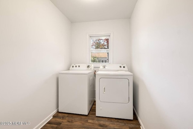 clothes washing area featuring washer and clothes dryer, dark wood-style floors, and baseboards