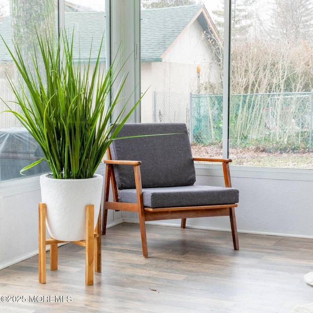 living area featuring wood finished floors and baseboards
