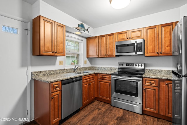 119B Buckingham Dr, Lakewood, NJ 08701 - kitchen with brown cabinetry, dark wood-style flooring, appliances with stainless steel finishes, light stone countertops, and a sink