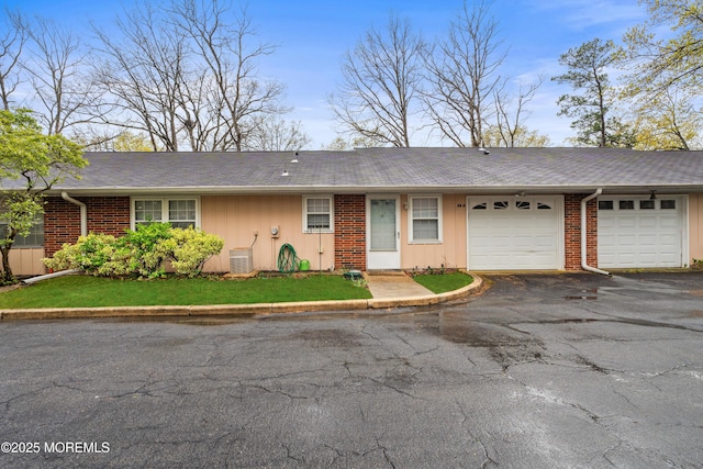119B Buckingham Dr, Lakewood, NJ 08701 - ranch-style home featuring roof with shingles, brick siding, a garage, board and batten siding, and driveway