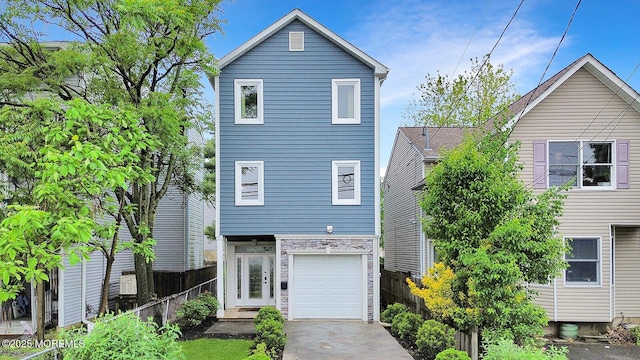 103 Carr Ave, Keansburg, NJ 07734 - view of front of house featuring fence, stone siding, a garage, and driveway