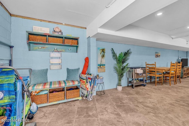 game room with concrete block wall