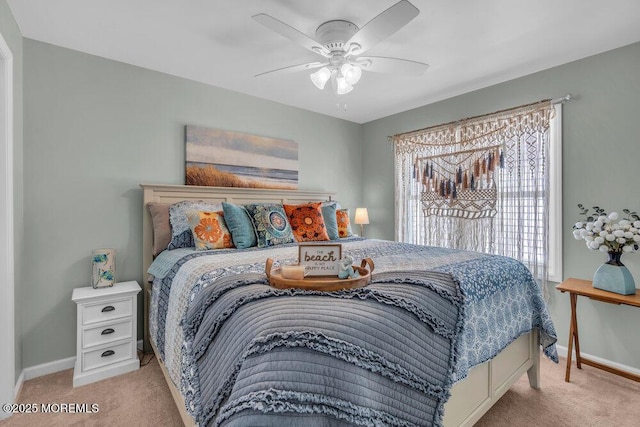 carpeted bedroom featuring baseboards and a ceiling fan