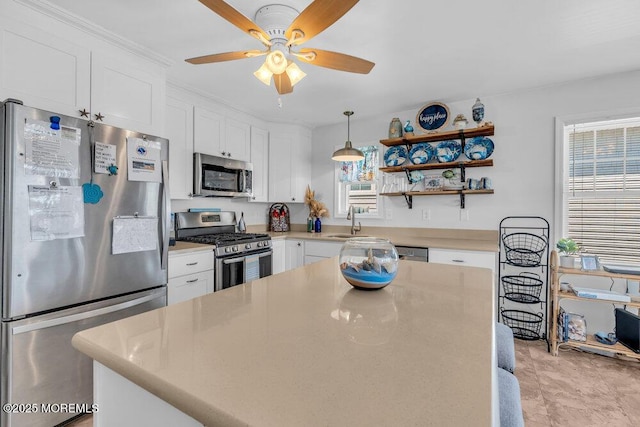 kitchen with white cabinets, ceiling fan, appliances with stainless steel finishes, and light countertops