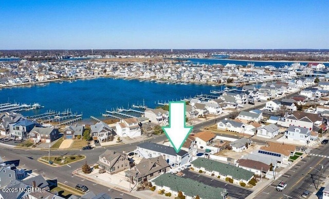 birds eye view of property featuring a residential view and a water view