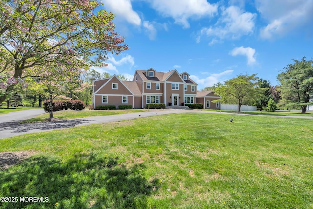 63 Carriage Hill Dr, Colts Neck, NJ 07722 - colonial house with fence, driveway, and a front yard