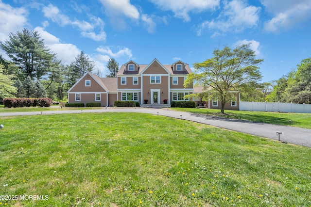 63 Carriage Hill Dr, Colts Neck, NJ 07722 - view of front of home with a front lawn and fence
