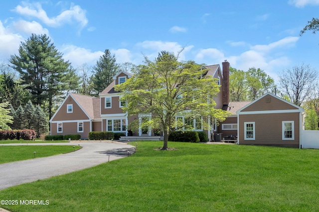 63 Carriage Hill Dr, Colts Neck, NJ 07722 - view of front facade featuring a front lawn and a chimney