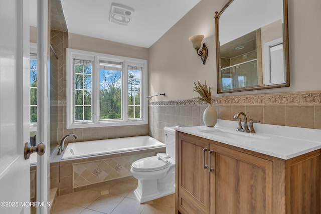 63 Carriage Hill Dr, Colts Neck, NJ 07722 - bathroom with vanity, toilet, tile patterned floors, tile walls, and tiled tub