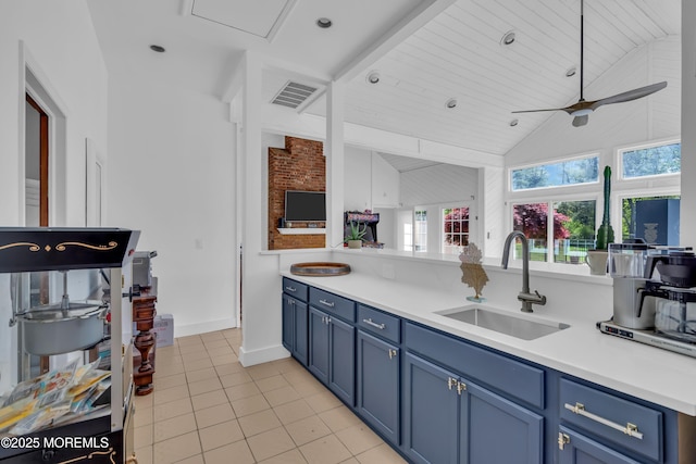 63 Carriage Hill Dr, Colts Neck, NJ 07722 - kitchen with light tile patterned flooring, ceiling fan, a sink, light countertops, and blue cabinetry