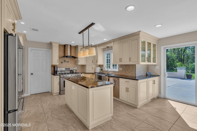 63 Carriage Hill Dr, Colts Neck, NJ 07722 - kitchen with backsplash, visible vents, appliances with stainless steel finishes, wall chimney exhaust hood, and cream cabinetry