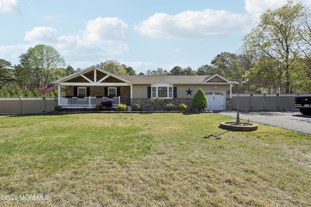 view of front facade with a front lawn, an attached garage, stone siding, a porch, and driveway