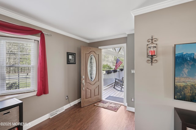 entrance foyer with baseboards, ornamental molding, dark wood finished floors, and visible vents