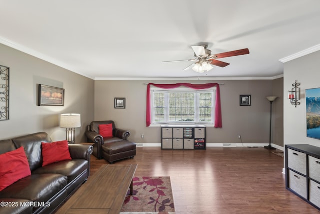 living area featuring crown molding, ceiling fan, baseboards, and wood finished floors