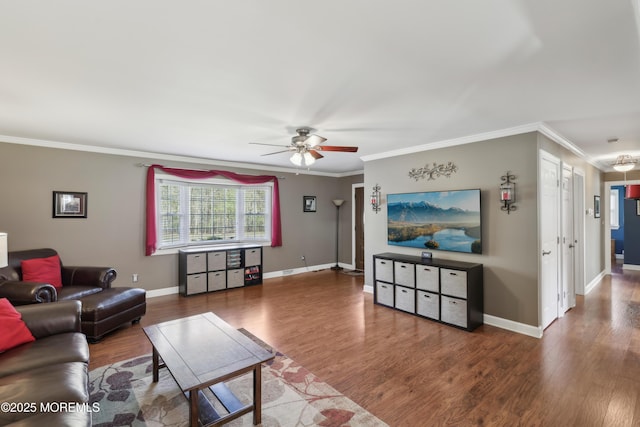 living area with crown molding, a ceiling fan, and wood finished floors