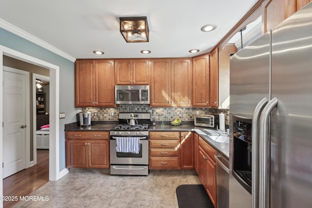 kitchen with brown cabinetry, backsplash, appliances with stainless steel finishes, ornamental molding, and recessed lighting